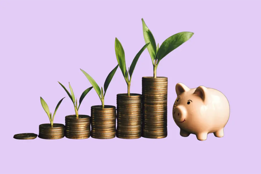 A pink piggy bank sits beside stacks of gold coins arranged in ascending order, each topped with a small green plant sprout, symbolizing financial growth and savings on a light purple background.